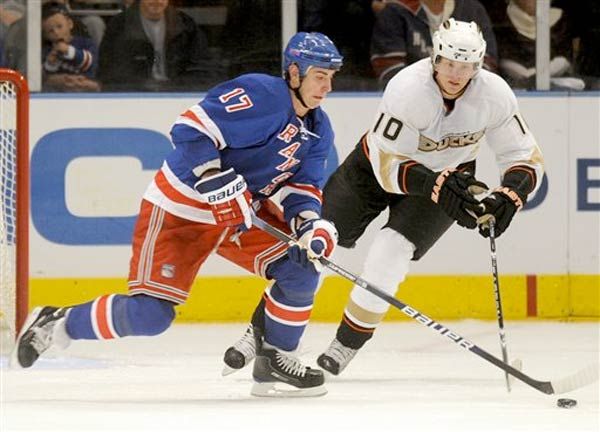 The Rangers' Brandon Dubinsky, left, and Anaheim Ducks' Corey Perry fight over a puck